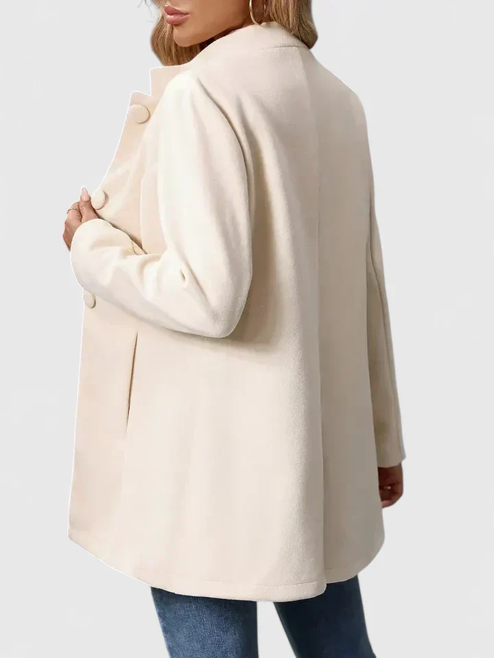 Jacka dam med knappar — elegant och kragelös i knälång modell - Bild 6